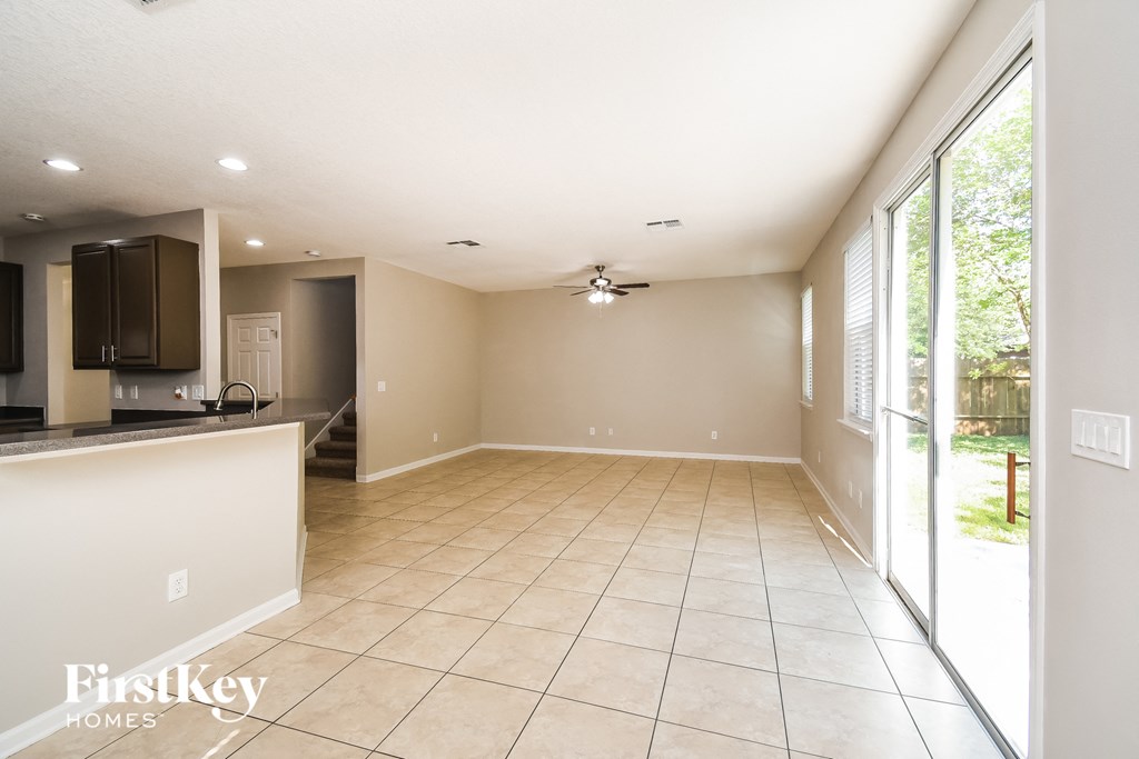 an empty kitchen and living room with a large window