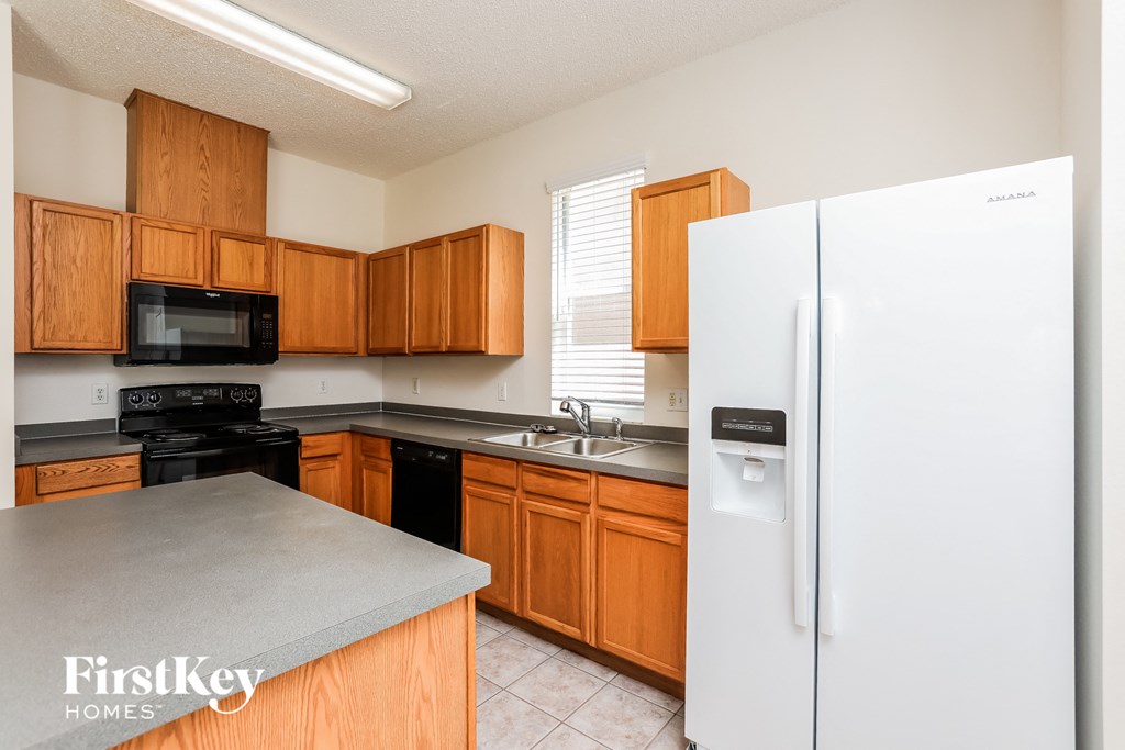 a kitchen with wooden cabinets and a white refrigerator