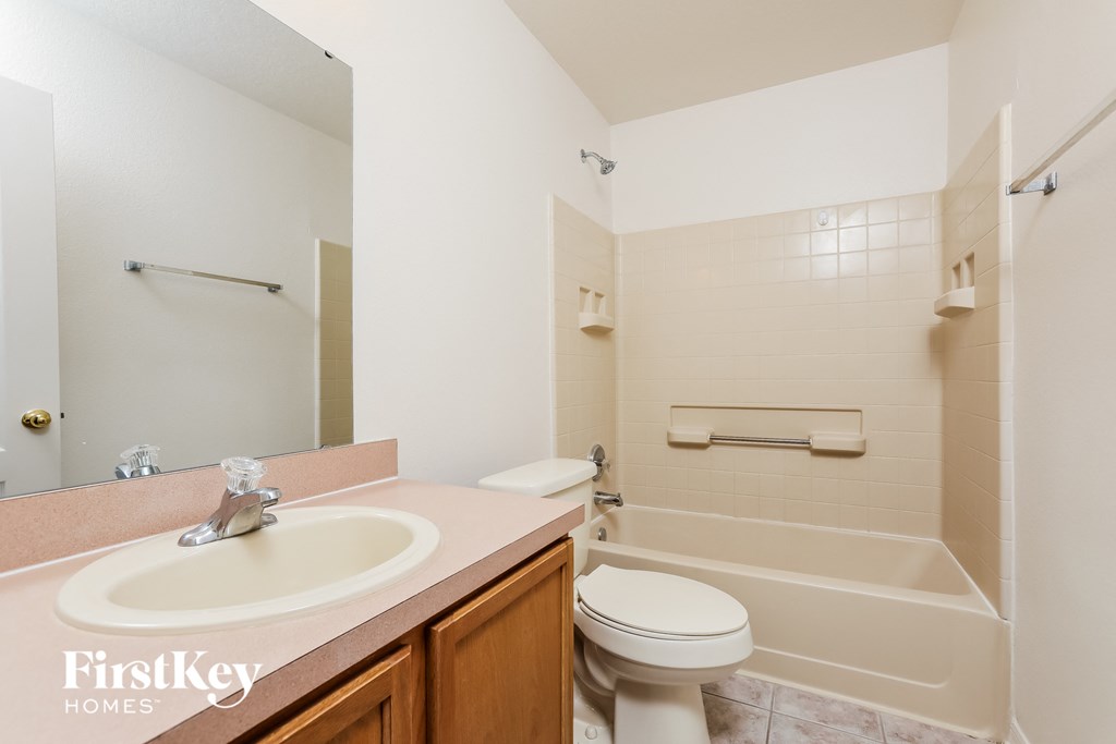 a bathroom with a sink toilet and a bath tub