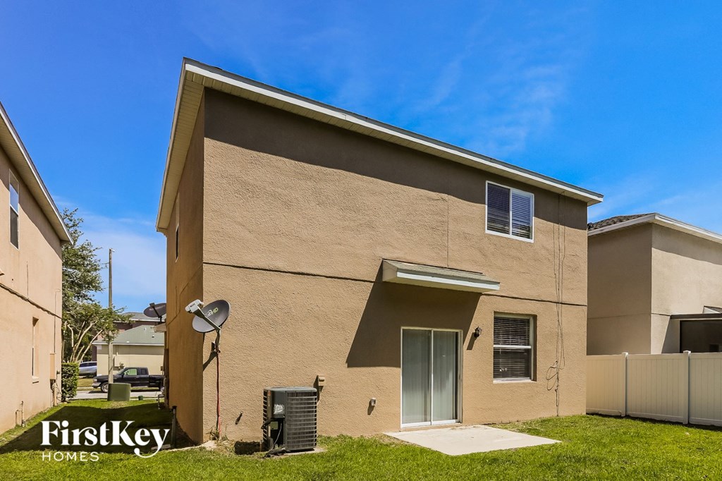 a tan building with a satellite dish on the side of it