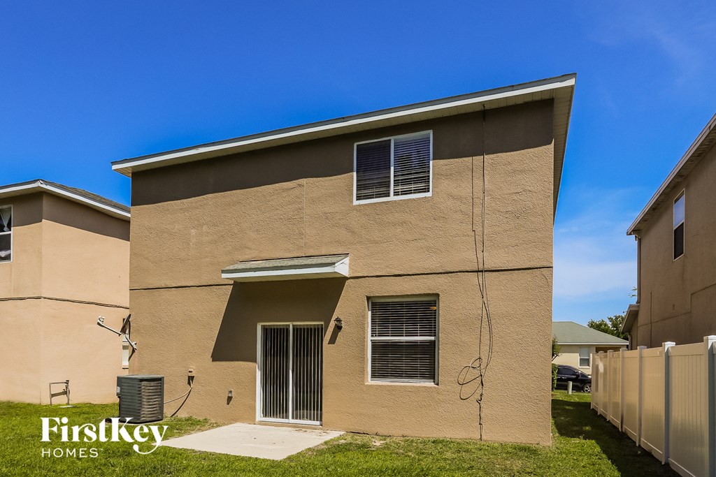 a brown house with two windows on the side of it