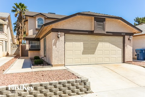 a house with a white garage door in front of it