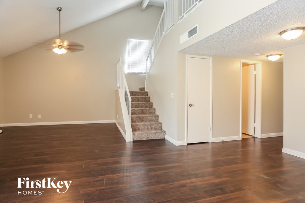 the living room with stairs to the 2nd and 3rd floors