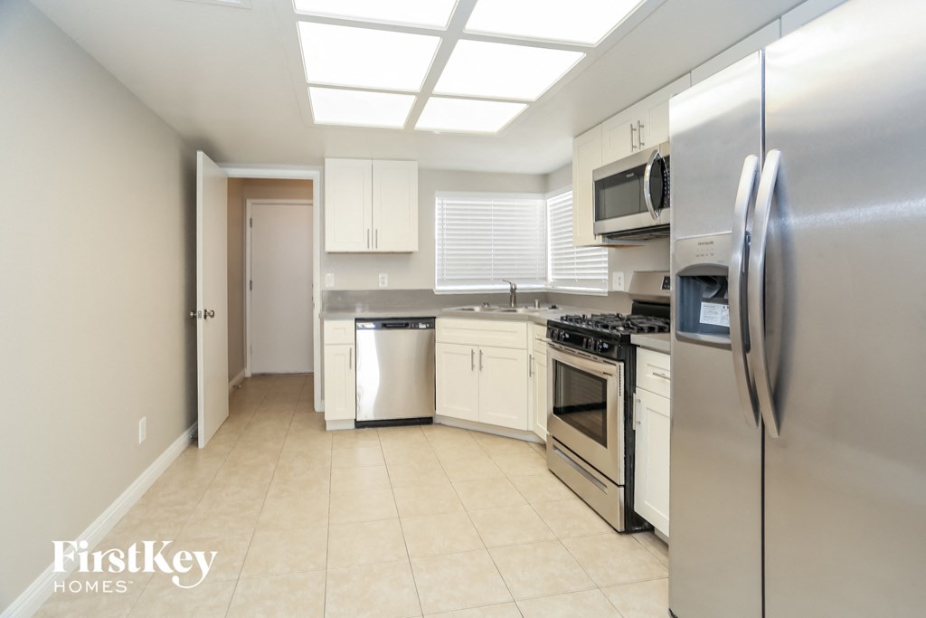 a kitchen with stainless steel appliances and white cabinets
