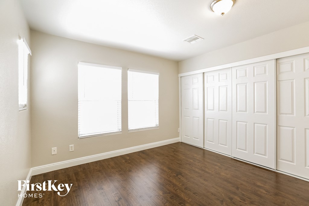 the living room of a new home with wood floors and white walls