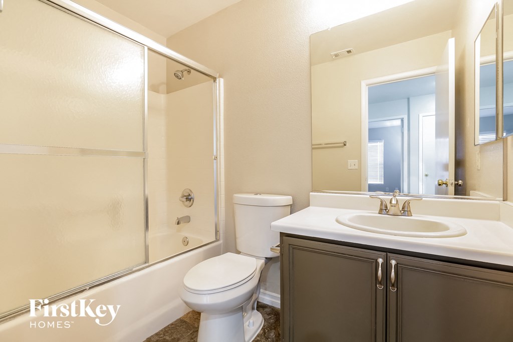 a bathroom with a toilet sink and a shower