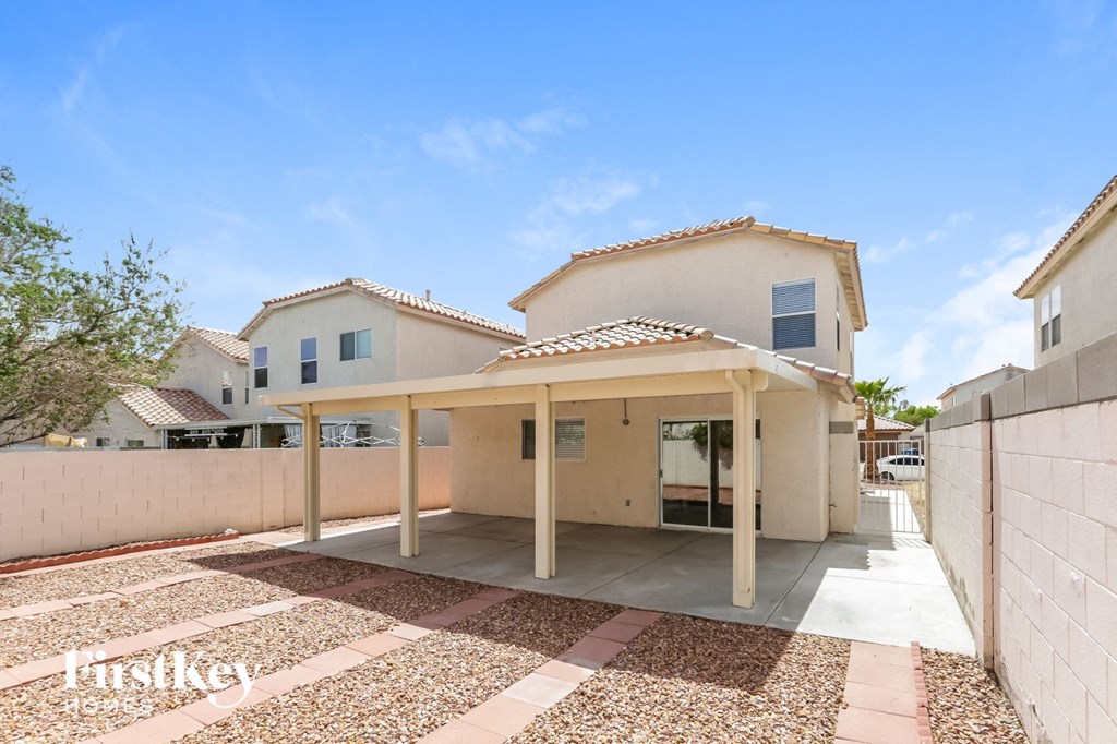 a white house with a covered patio in front of it