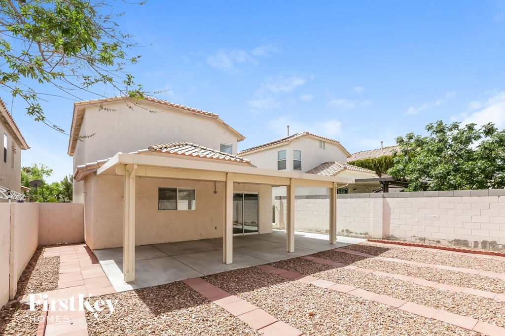 a white house with a white wall and a patio