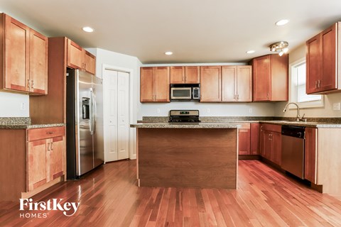 a kitchen with wooden cabinets and stainless steel appliances