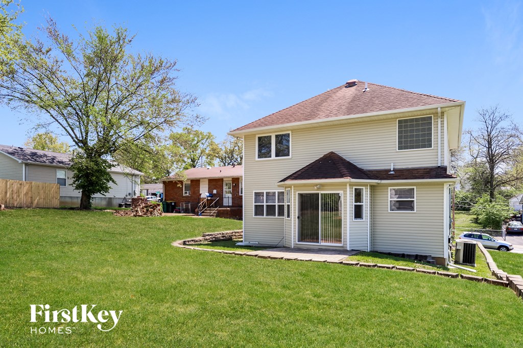 a white house with a yard in front of it