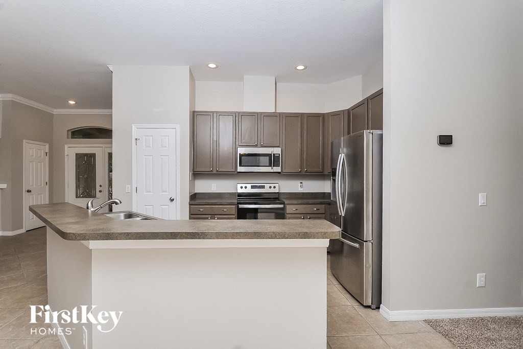 a kitchen with stainless steel appliances and a counter top