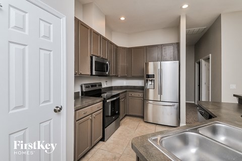 a kitchen with stainless steel appliances and wooden cabinets