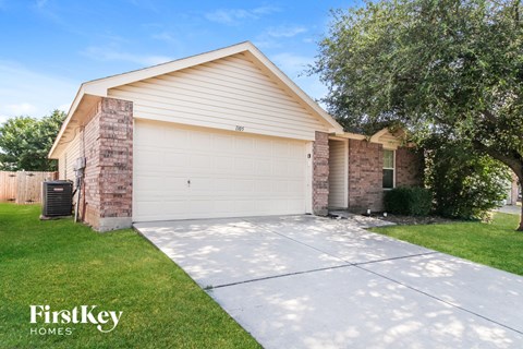 A house with a garage and a driveway is for sale.