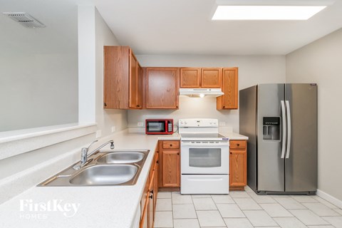 A kitchen with wooden cabinets and stainless steel appliances.