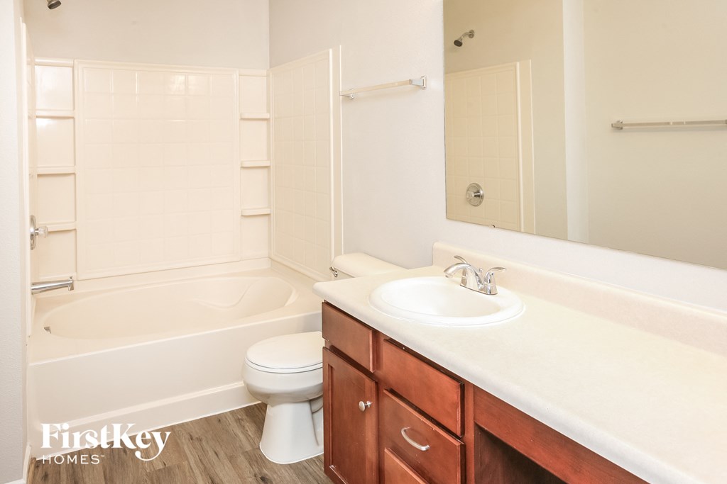 a bathroom with a sink toilet and bath tub
