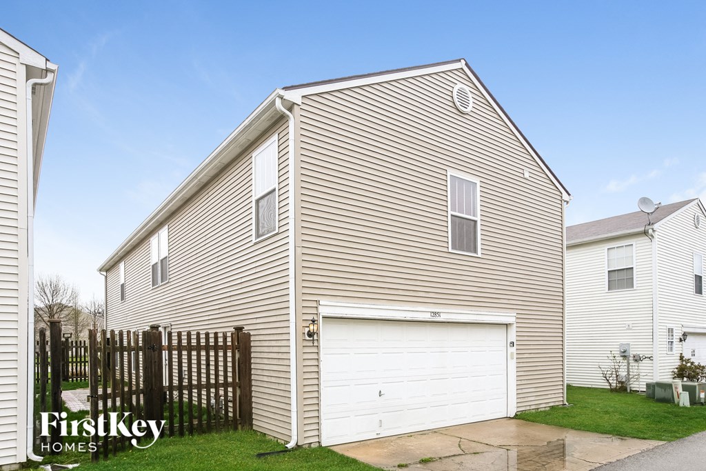 the outside of a house with a white garage door