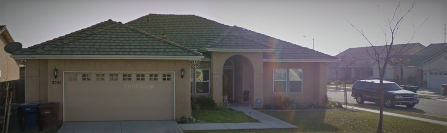 a house with a tiled roof and a garage door