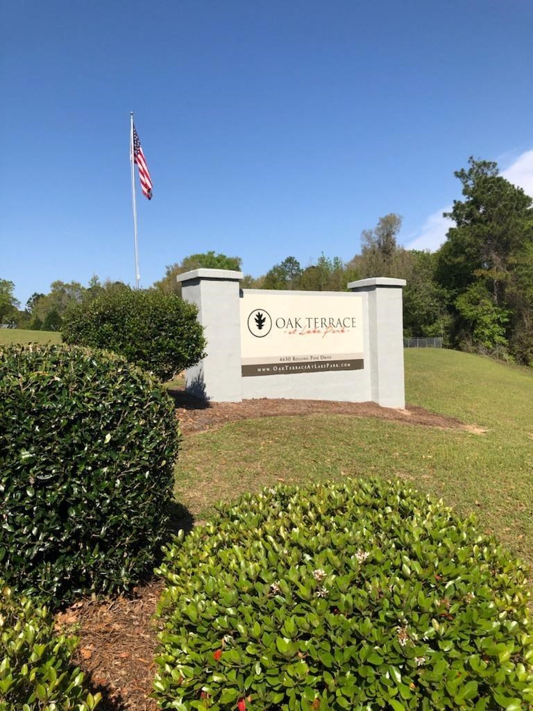 a sign with an flag in front of a building