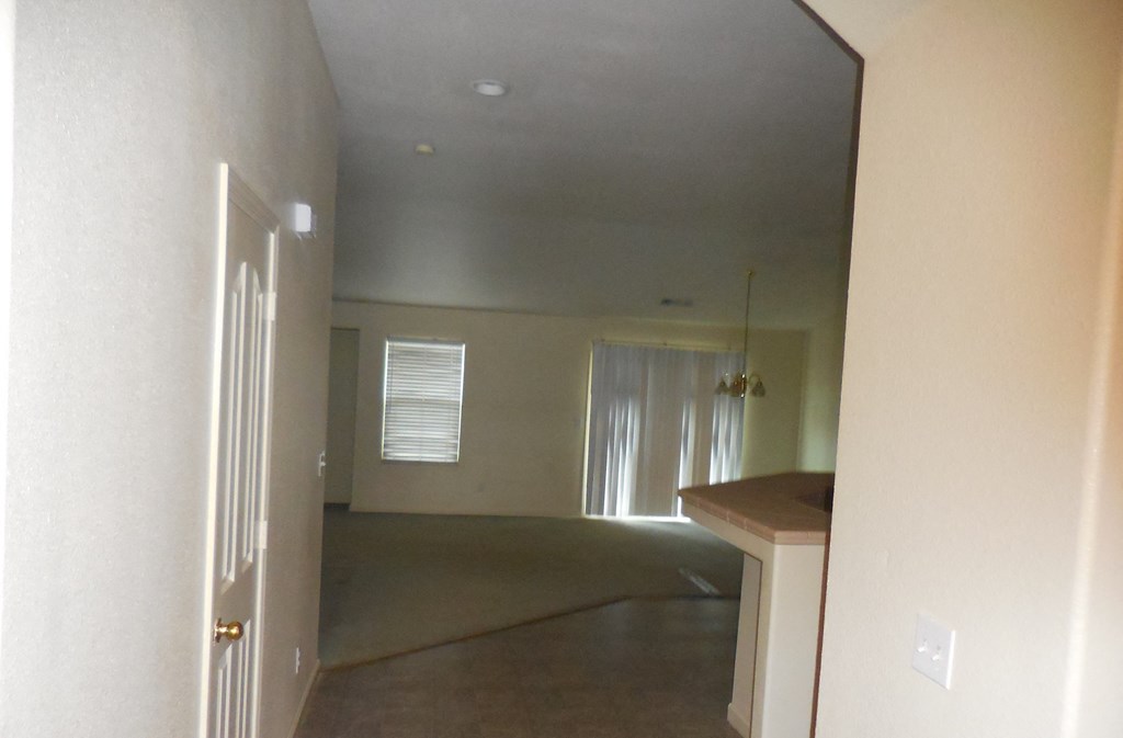 a view of an empty living room from the kitchen