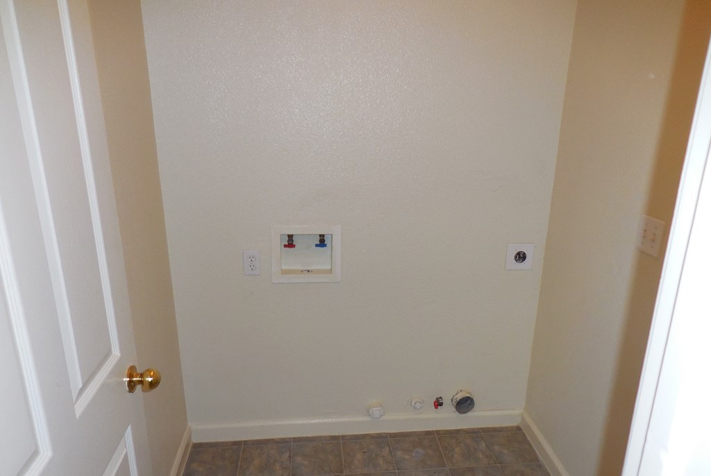 a wall with an electrical outlet and a door