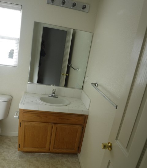 a small bathroom with a sink and a mirror