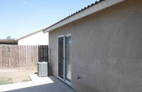a side view of a house with a heater outside