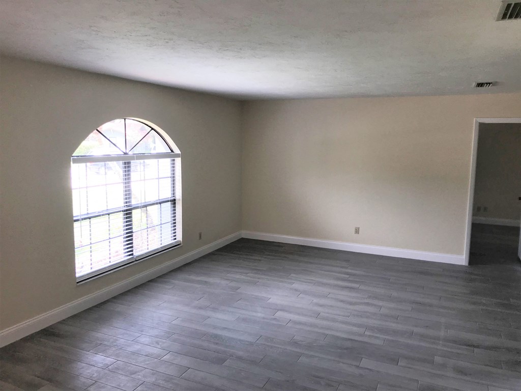 an empty living room with a large window