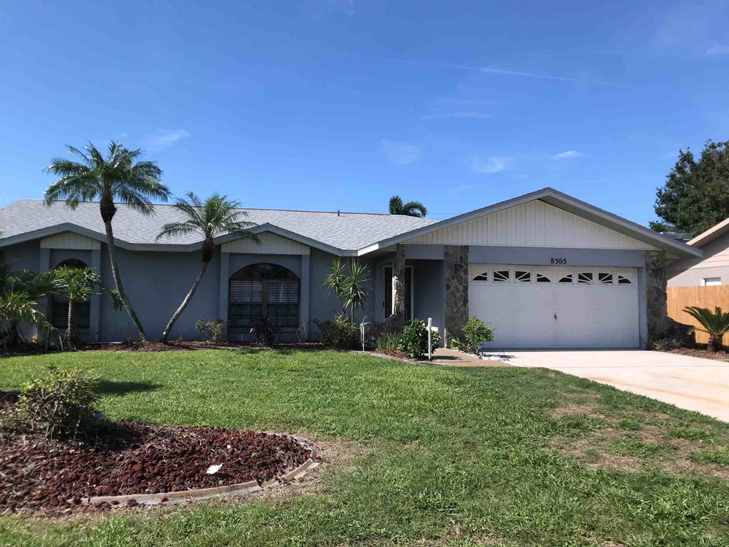 a house with palm trees in front of it