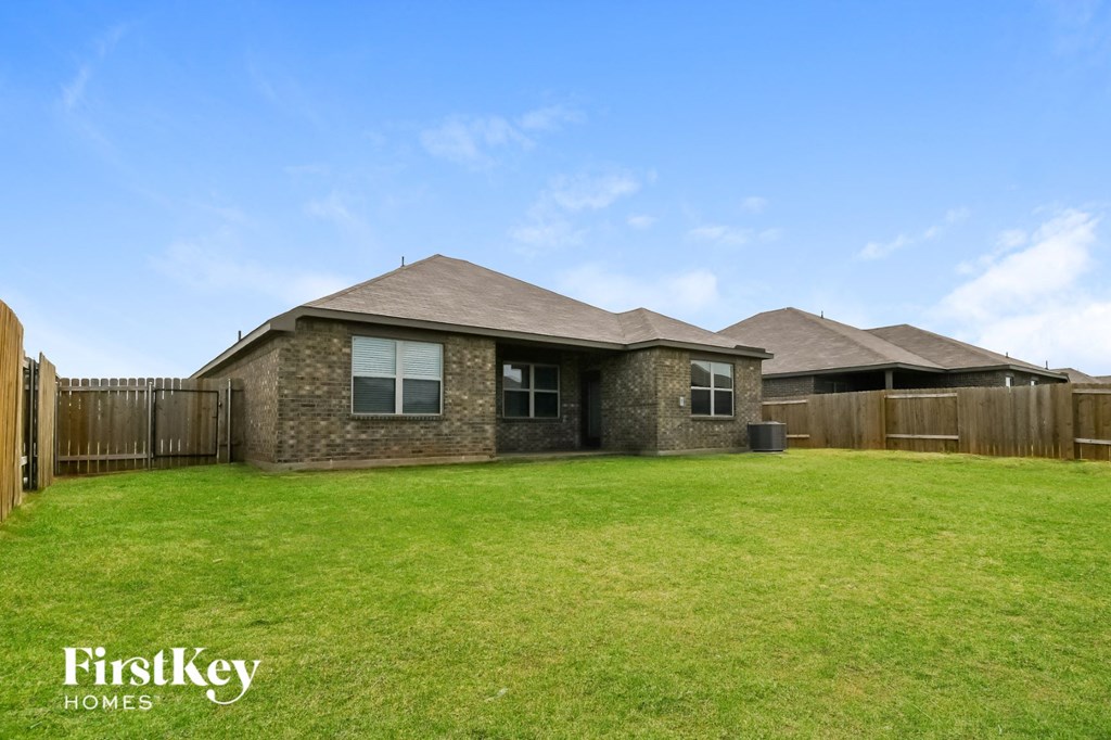 a house with a yard and a wooden fence