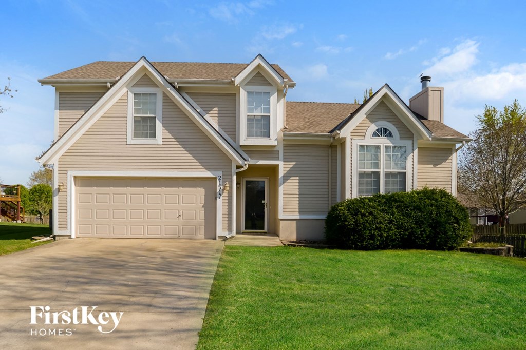 A two-story house with a garage is for sale by FirstKey Homes.
