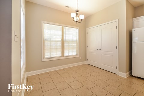 a dining room with a large window and a white door