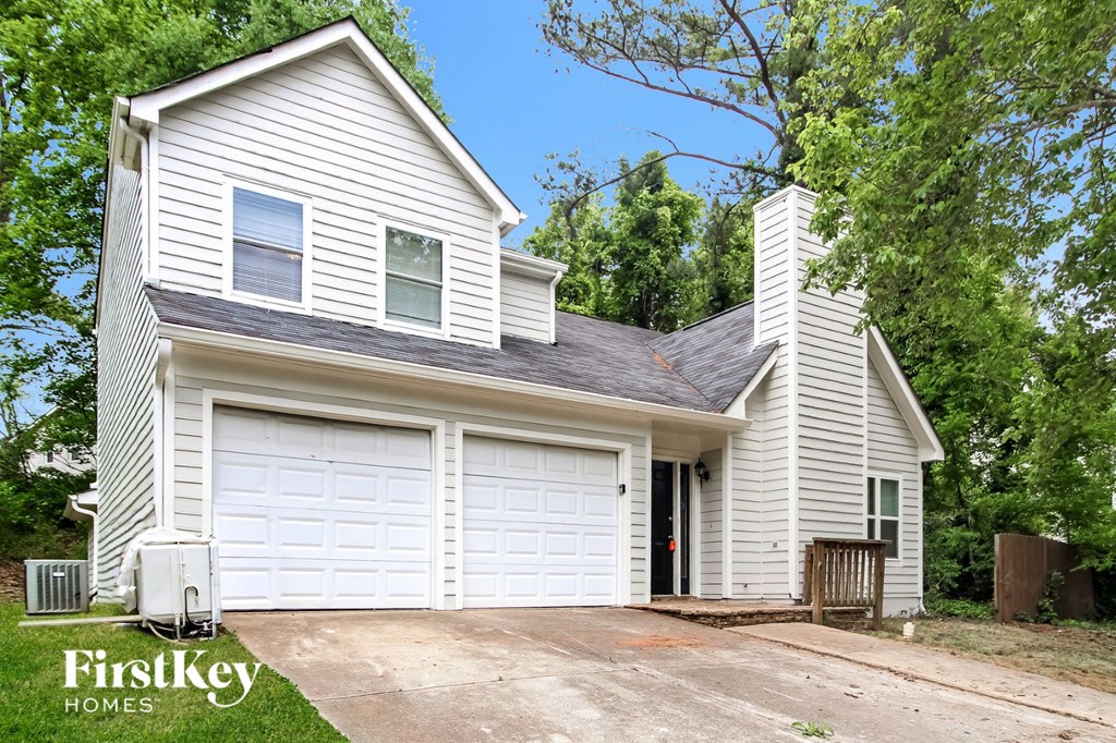 a white house with a white garage door