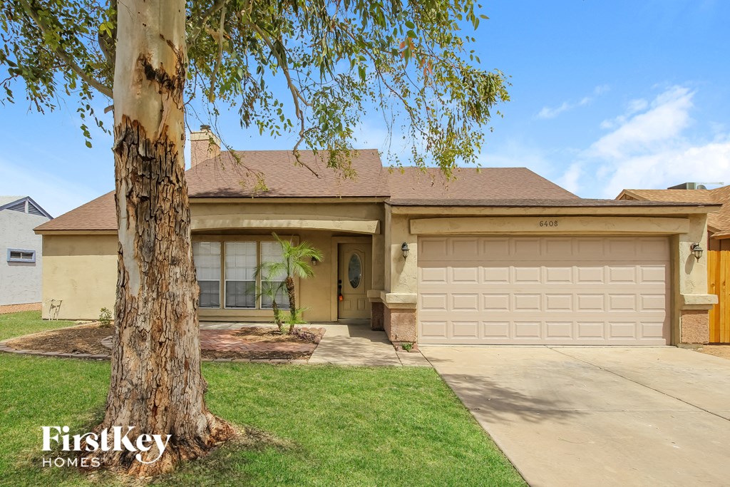 A house with a tree in front of it.