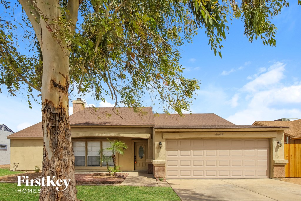 A house with a tree in front of it.