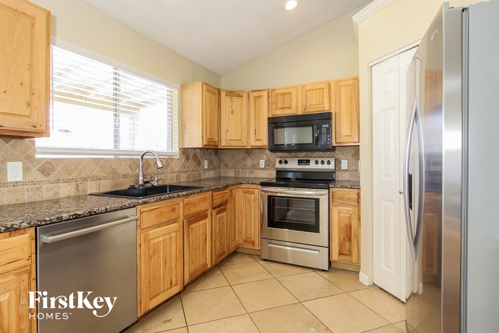 A kitchen with wooden cabinets and stainless steel appliances.