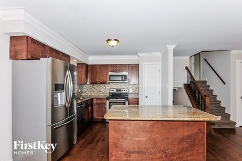 a kitchen with stainless steel appliances and a marble counter top