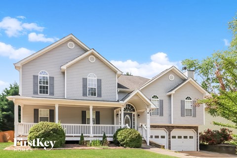 a with a white porch and a white fence