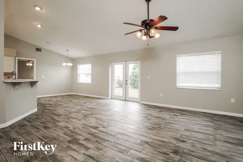 the living room is open to the dining room and kitchen