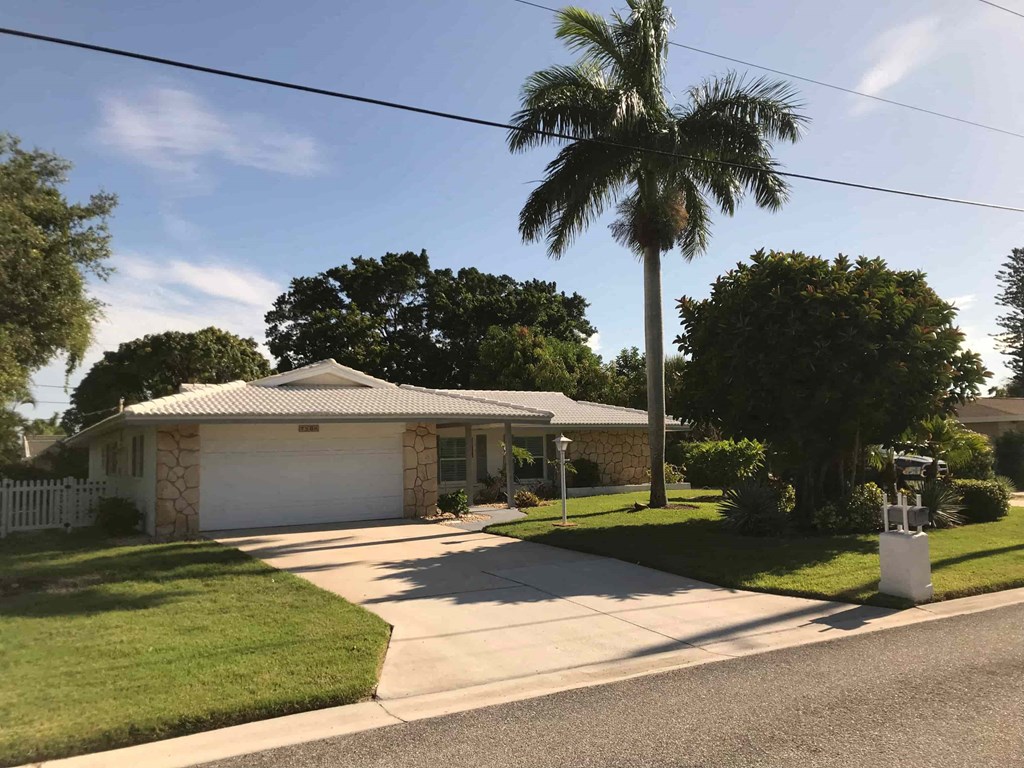 a house with a palm tree in front of it