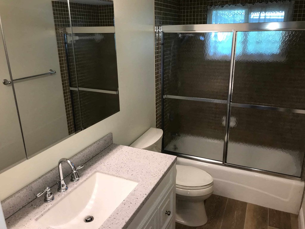 a bathroom with a sink toilet and shower