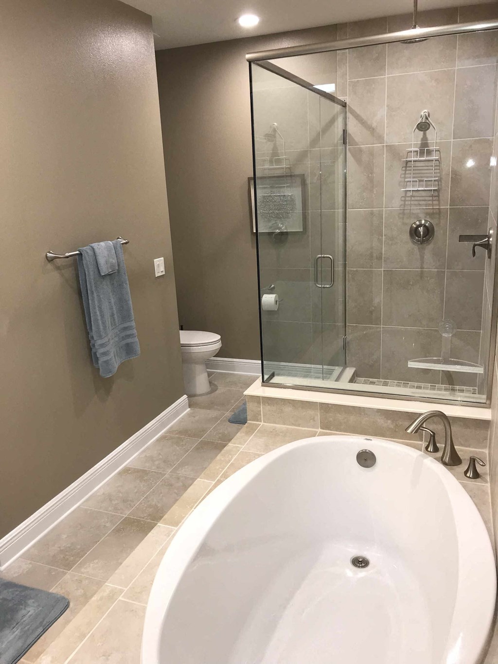 a large bathroom with a large tub and a glass shower