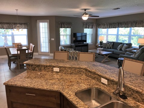 the view from the kitchen into the living room and dining room