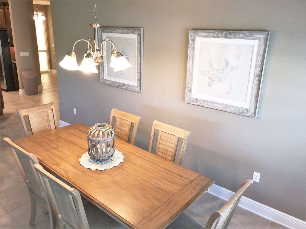 a dining room with a wooden table and a chandelier