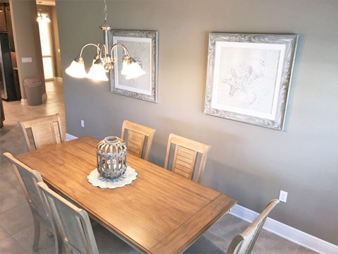 a dining room with a wooden table and a chandelier