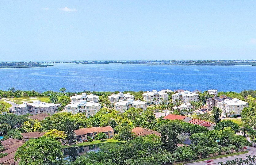 an aerial view of a neighborhood with a lake in the background