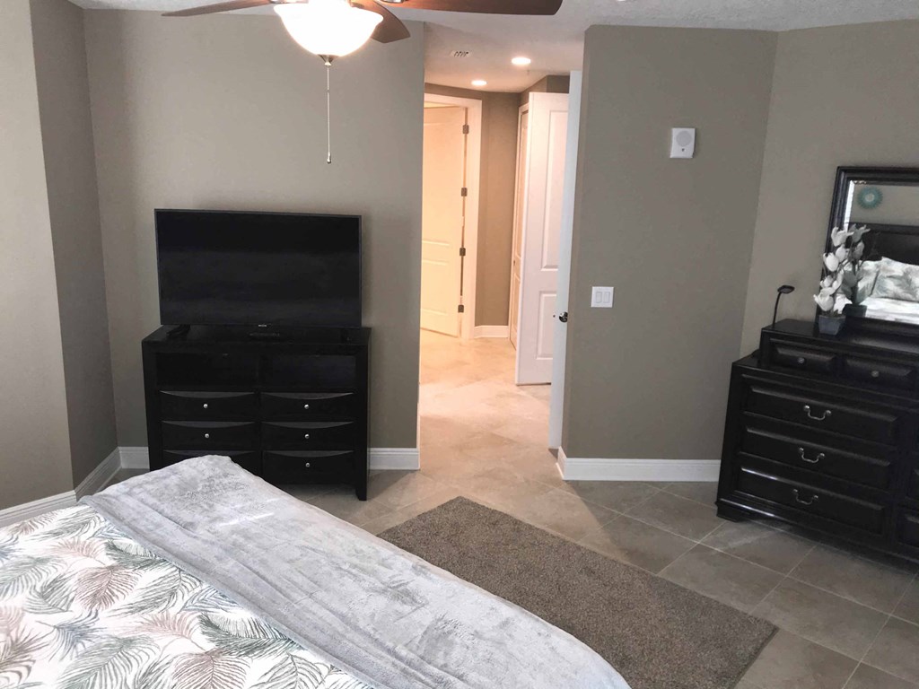 a bedroom with a bed and a tv