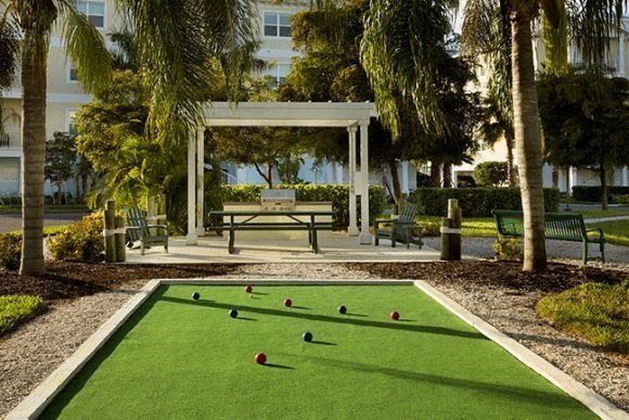 a bocce ball court in a park with a picnic table