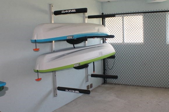 two surfboards hanging on a wall in a room