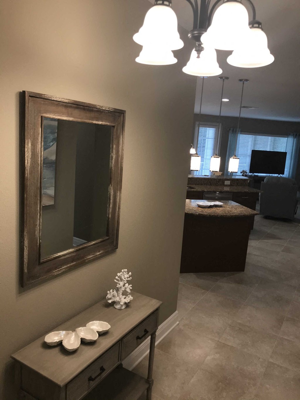 a mirror and a table with plates on it in a living room