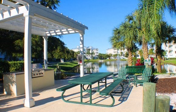 a group of picnic tables sitting next to a lake